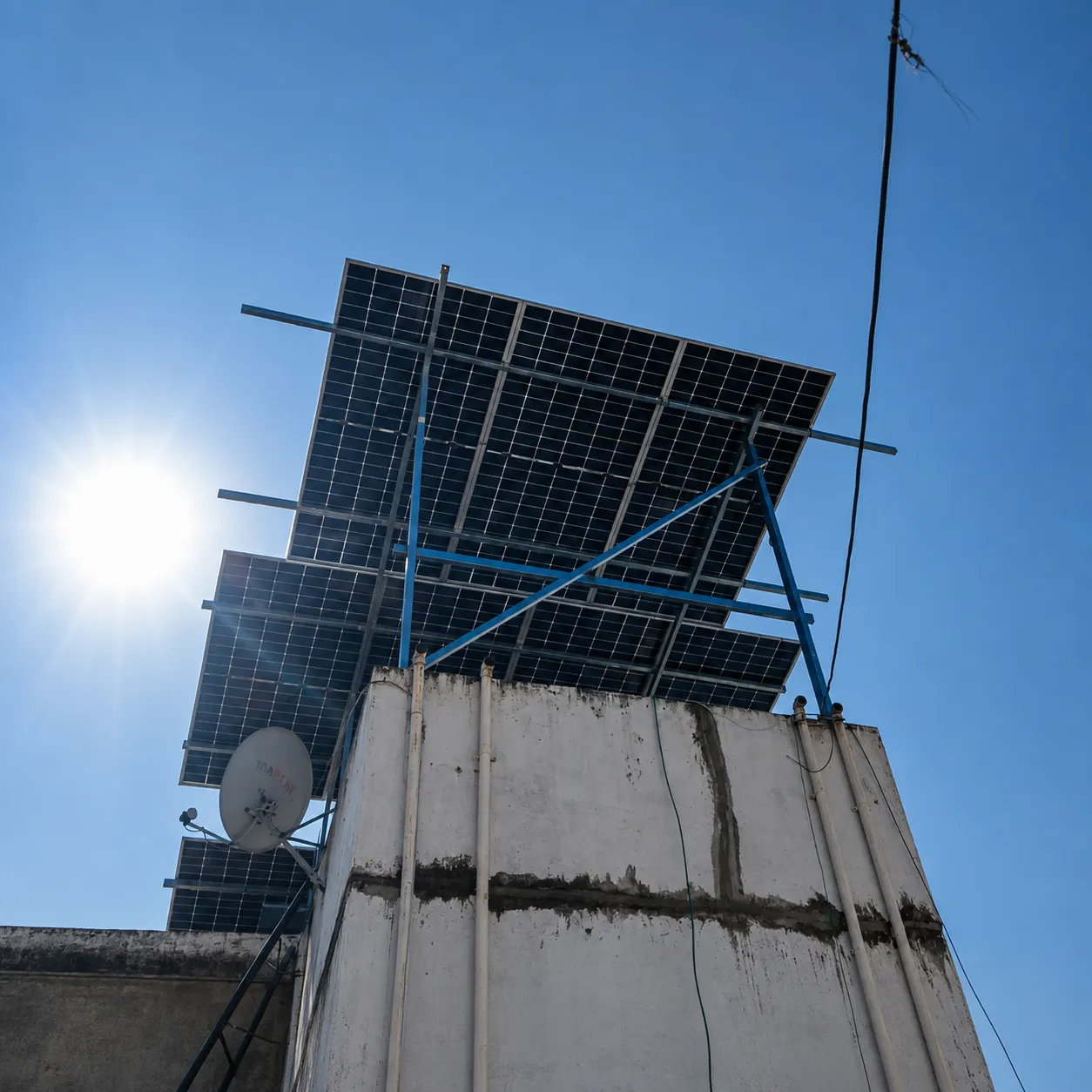 Elevated residential rooftop solar panels in bright sunlight