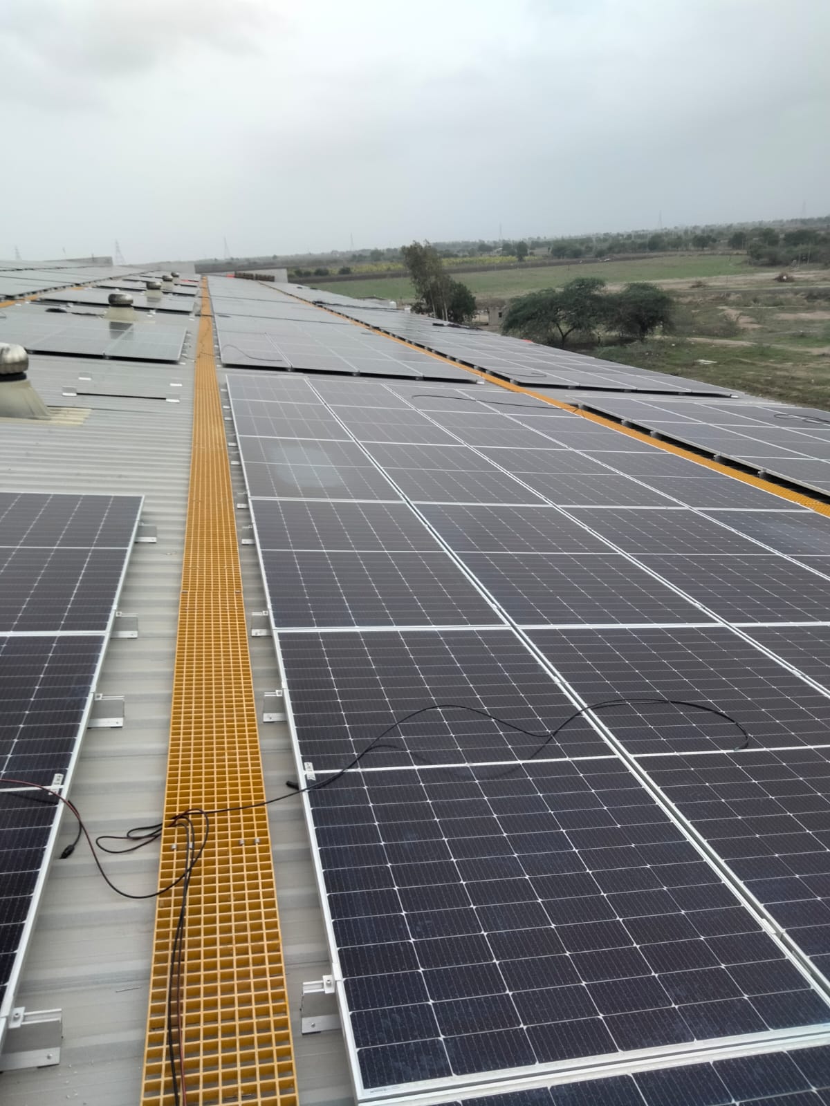 Large industrial rooftop solar array with a safety walkway